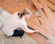 stock-photo-68807957-woman-installing-laminate-flooring