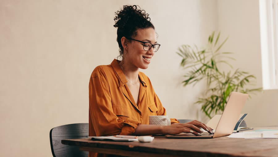 A woman is smiling while applying for credit union membership.