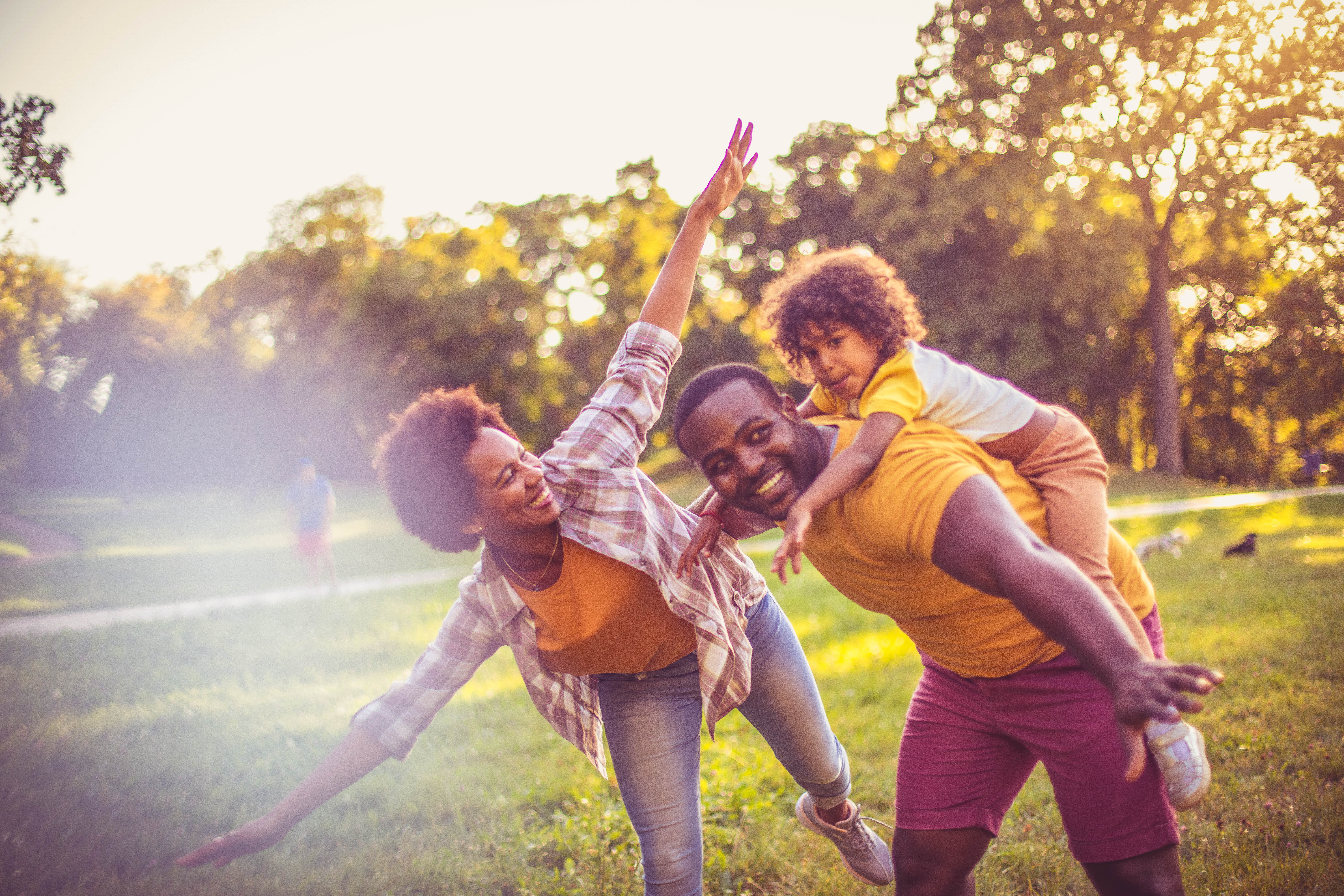 A family of three having fun together in a park